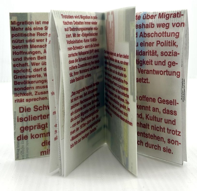 the folded zine standing open, pages fanned out
