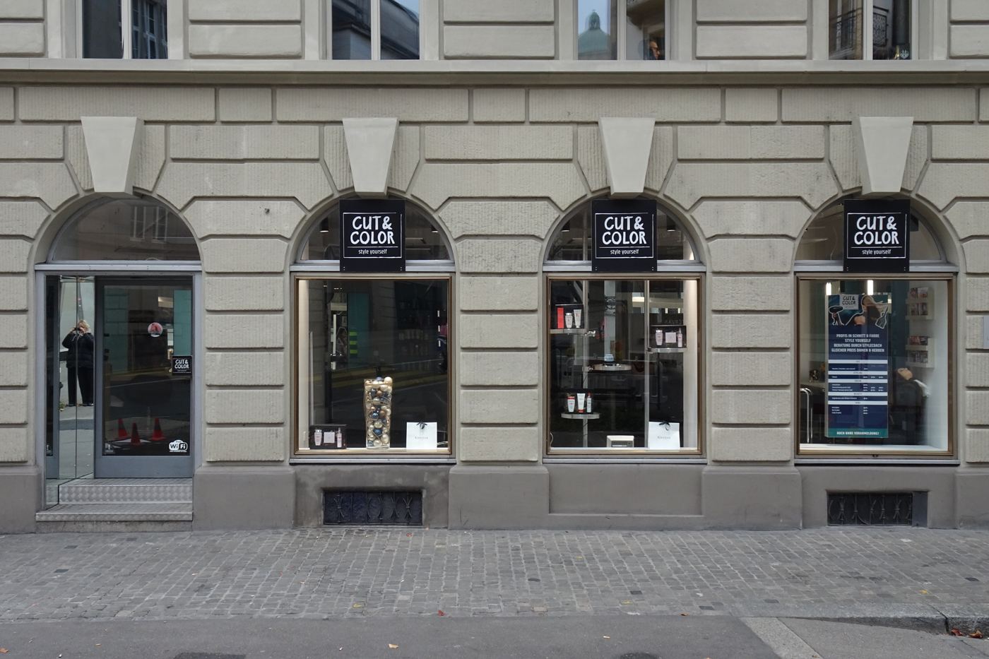 Cut & Color, three arched windows with identical black signs
