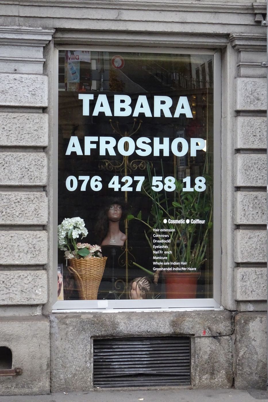 Tabara Afroshop, window lettering and a wig on a mannequin head